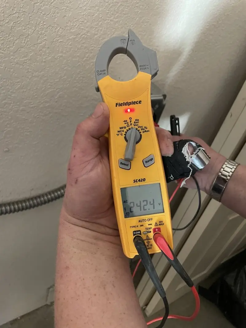 Voltage testing with clamp meter during Whole House Surge Protector in Canfield